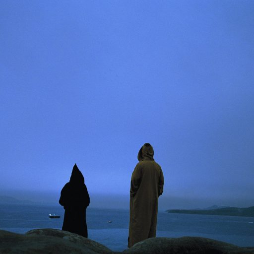 Moroccans look across the ocean towards Europe near the city of Tangier, January, 2002. Tangier is the northern-most city in Morocco and the last stop for most refugees heading to Europe in search of a new and better life.