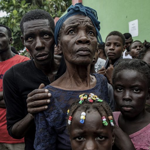 Les Cayes,Haiti, Aug 19th, 2021. Earthquake victims wait in line for drinking water distributed by a local charity group outside a soccer field turned into a makeshift camp for survivors in Les Cayes, Haiti. The 7.2-magnitude earthquake that rocked southern Haiti on Aug. 14, killing 2,200 people, struck a country already in crisis, with few legitimately elected officials and a paralyzed, unpopular and underfunded caretaker administration. © Adriana Zehbrauskas.